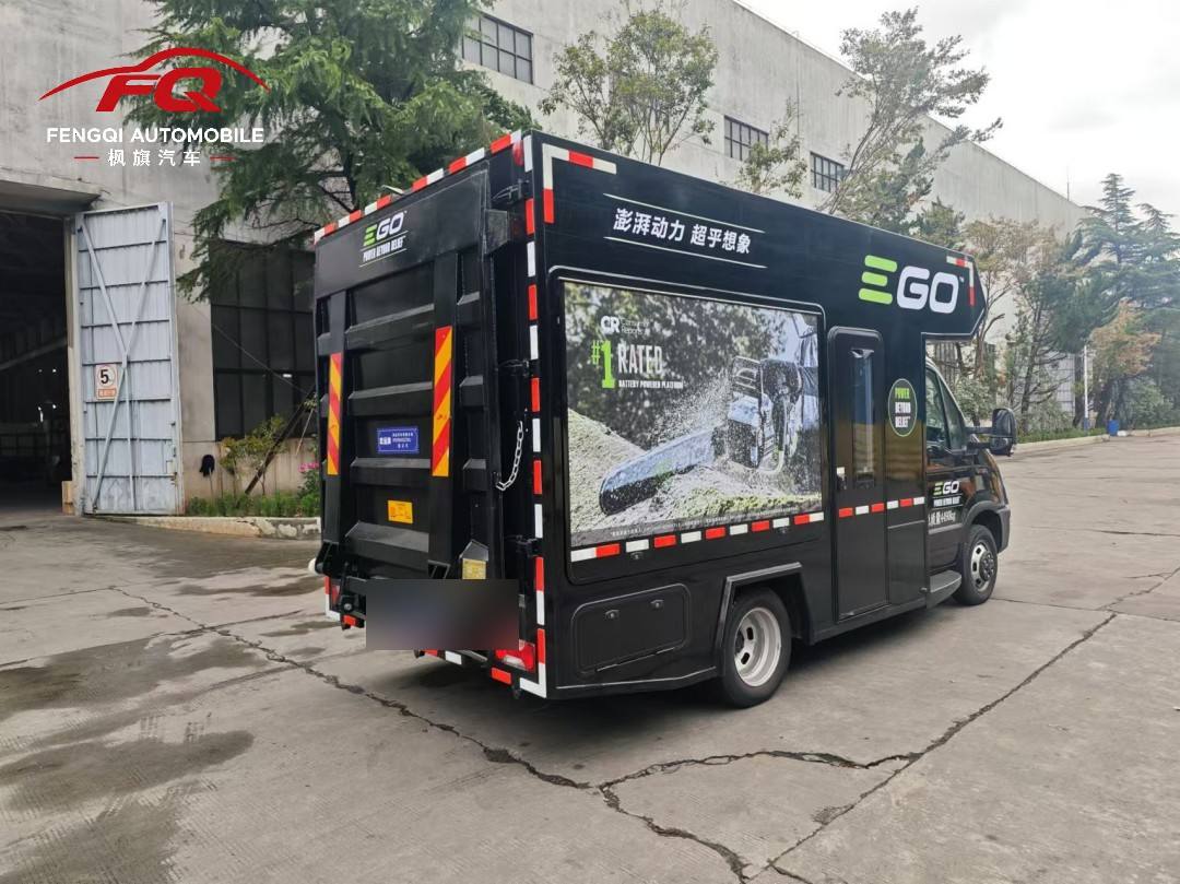 Rear of the display vehicle with hydraulic tail lift and exterior equipment bays housing the power system